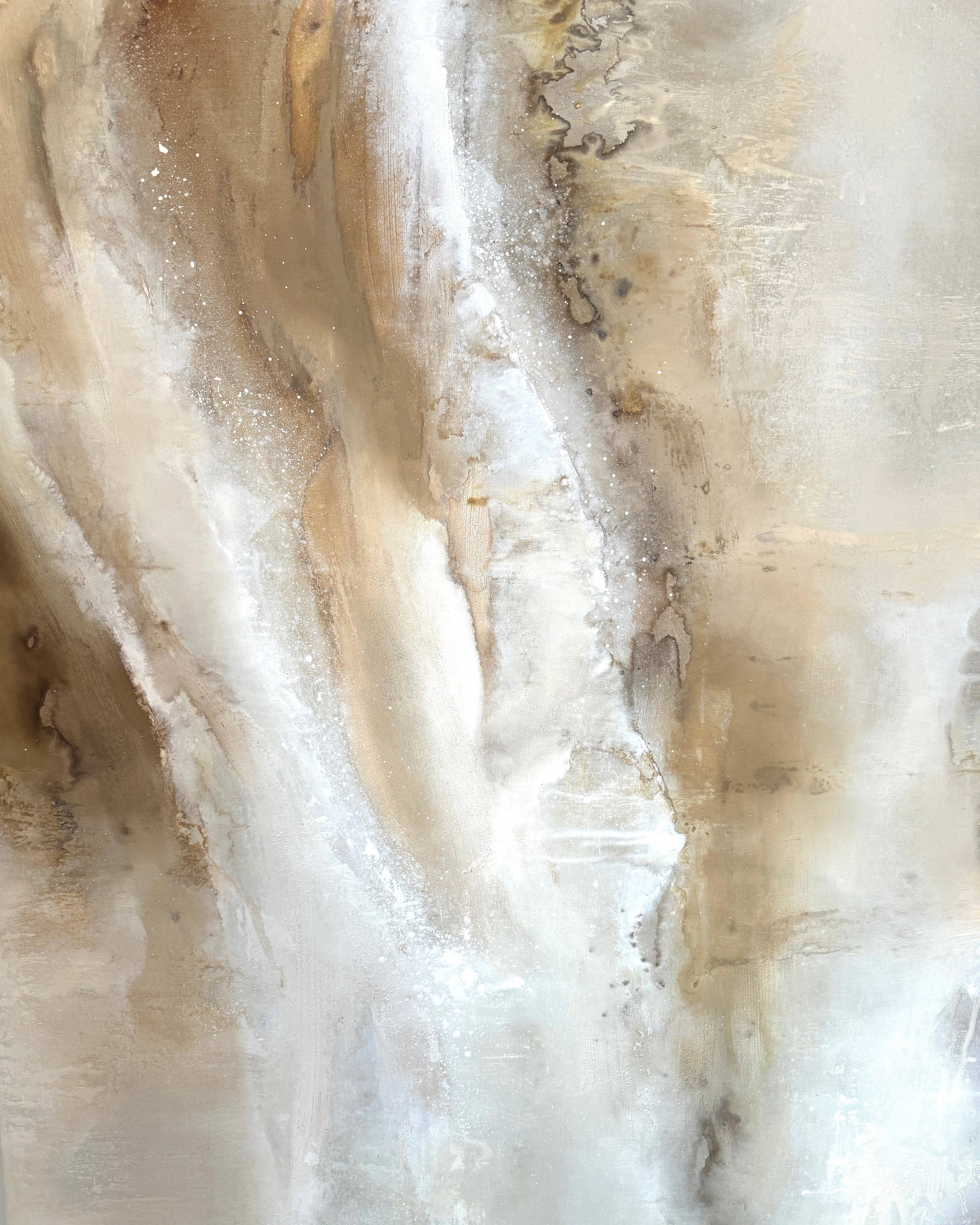 Close-up of a textured stone surface with beige and brown tones