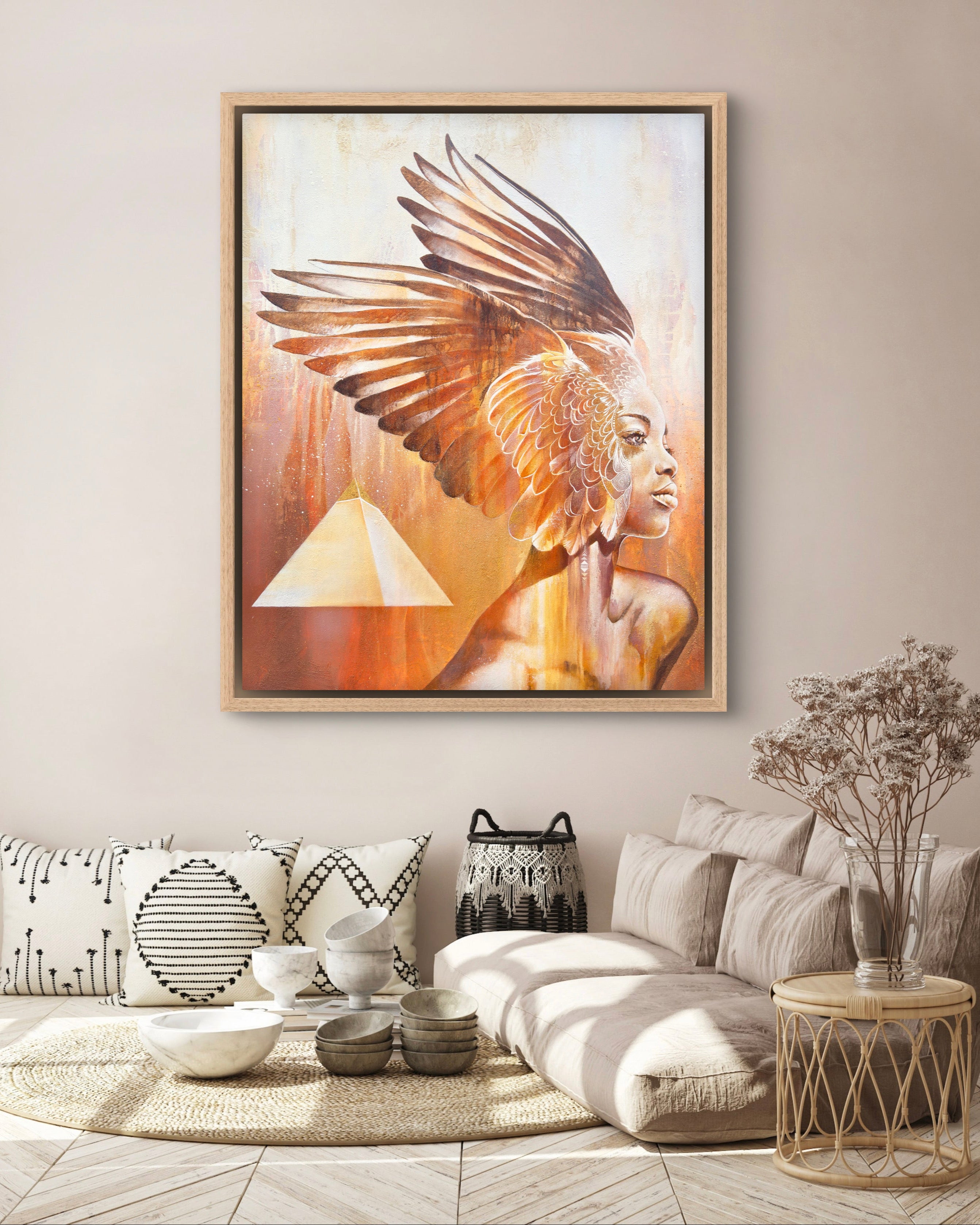 Framed artwork of a woman with wings in a living room setting.