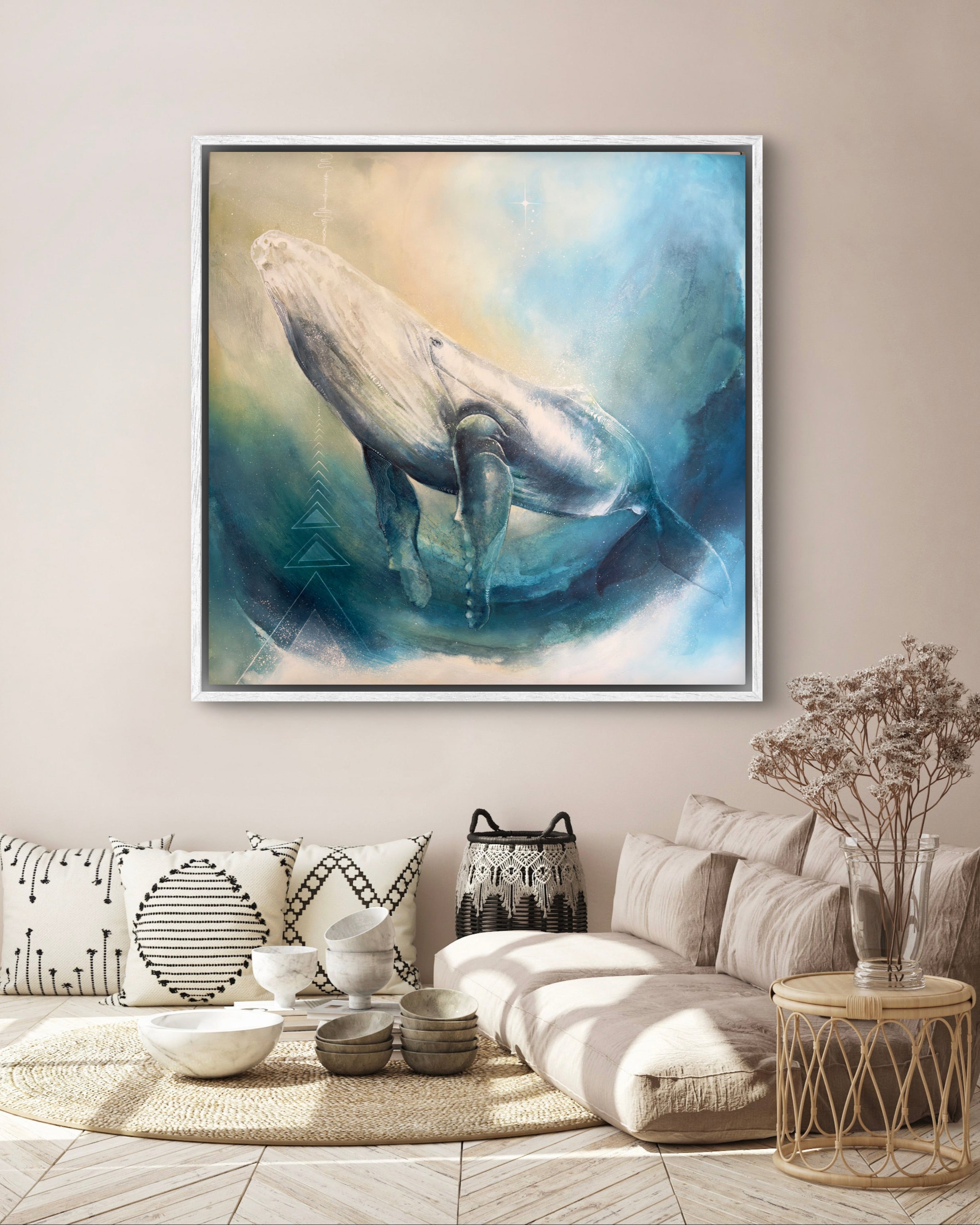 Framed whale painting on a wall in a living room with decor elements.
